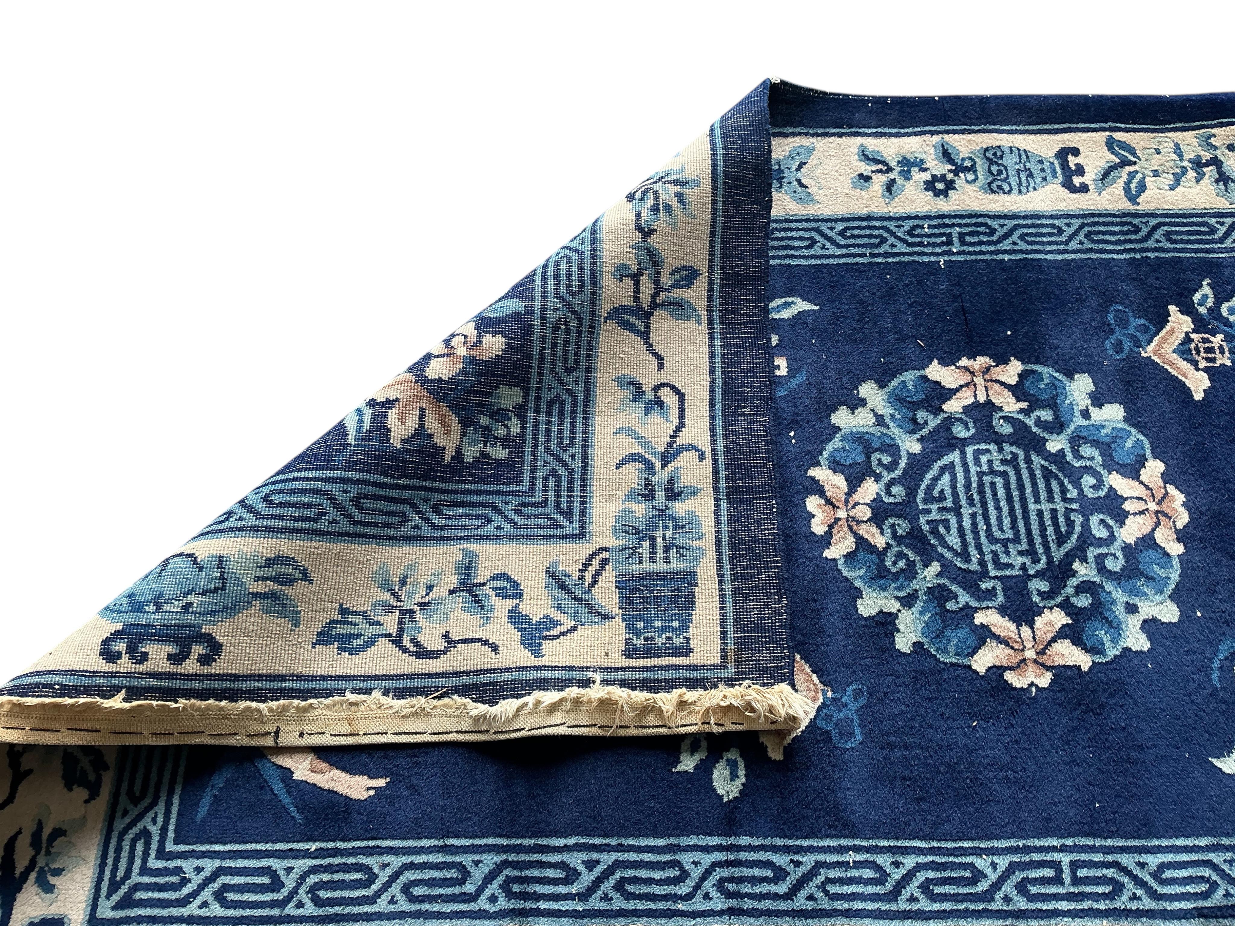 A Chinese blue ground rug, 210 x 124cm
